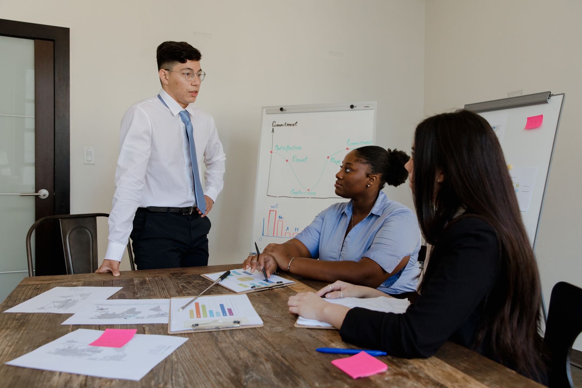 A group of professionals in a meeting around a boardroom table